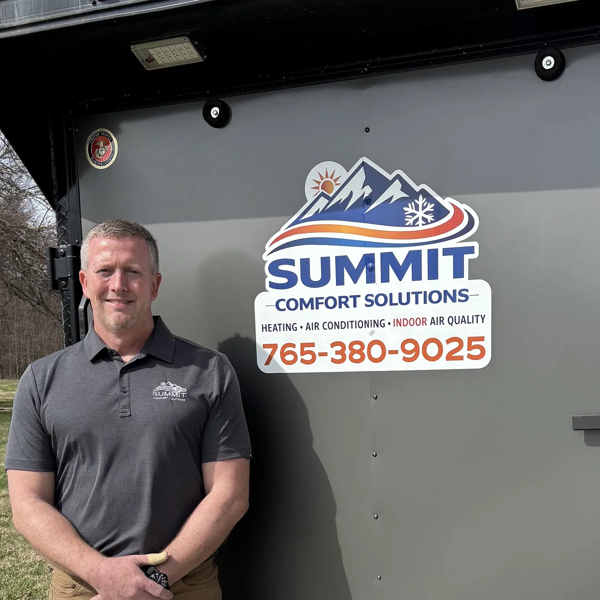 Summit Comfort Solutions HVAC owner beside the company's branded service trailer